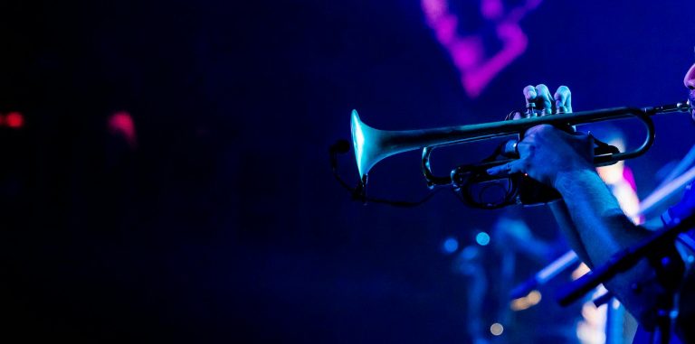 Vibrant image of a trumpeter playing during a live jazz concert, capturing the essence of musical performance.